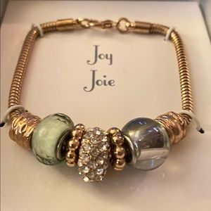 Gold colour metal bracelet with charms.